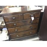 A pine chest of drawers fitted with two short and