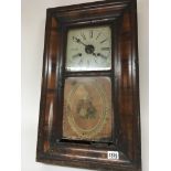 An American Victorian walnut wall clock with a gla