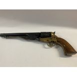 A replica Colt Navy revolver with engraved barrel, and brass and wooden grips.