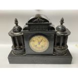 A Victorian black mantle clock.