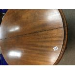 A Victorian mahogany loo table the oval top on cab