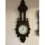 A Victorian carved oak barometer.