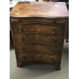 A walnut serpentine chest of drawers with a brushi