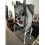A Paul Karslake designed and painted cabinet depicting Marilyn Monroe. Fitted with two doors over