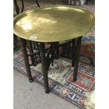 A brass topped Middle Eastern occasional table wit