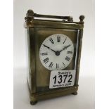 A brass cased carriage clock, the dial with Roman