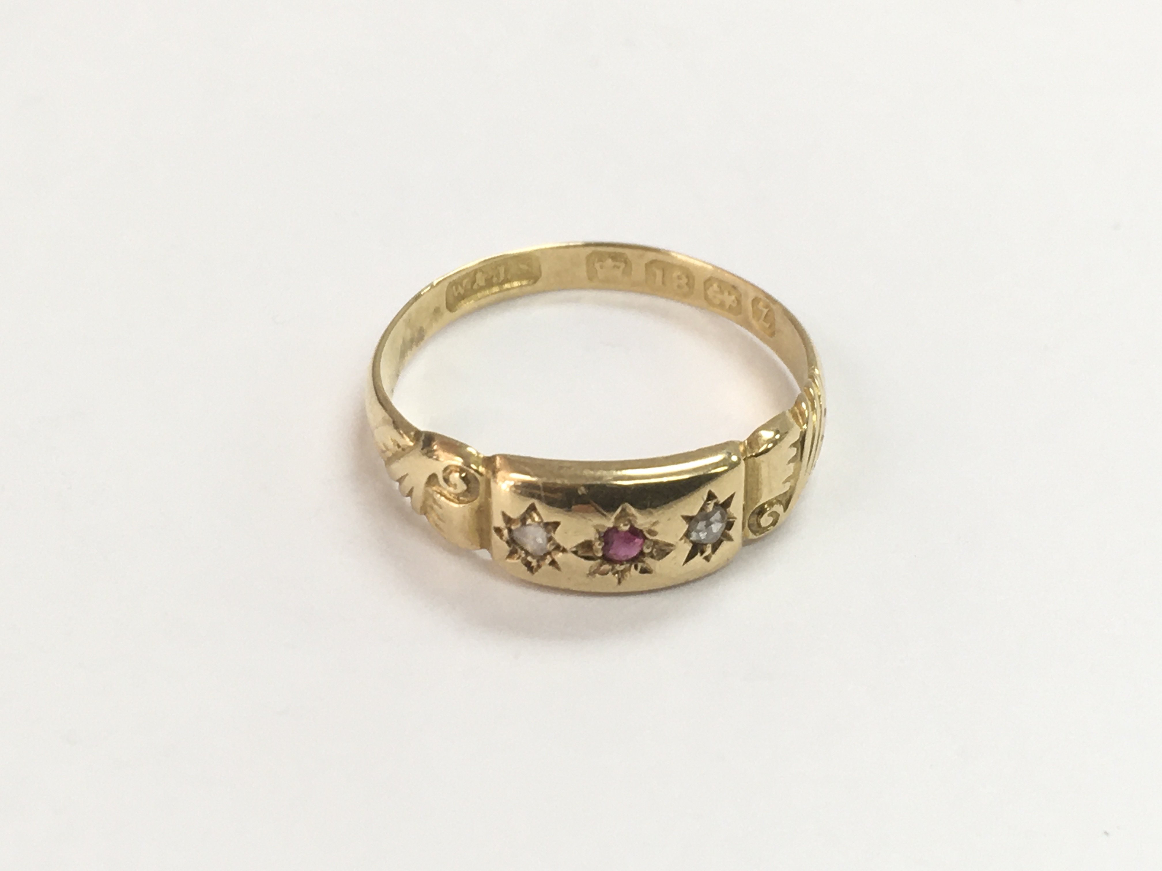An 18ct gold ring set with red and clear stones, a