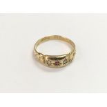 An 18ct gold ring set with red and clear stones, a