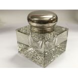 A silver topped glass inkwell of squared form, Bir