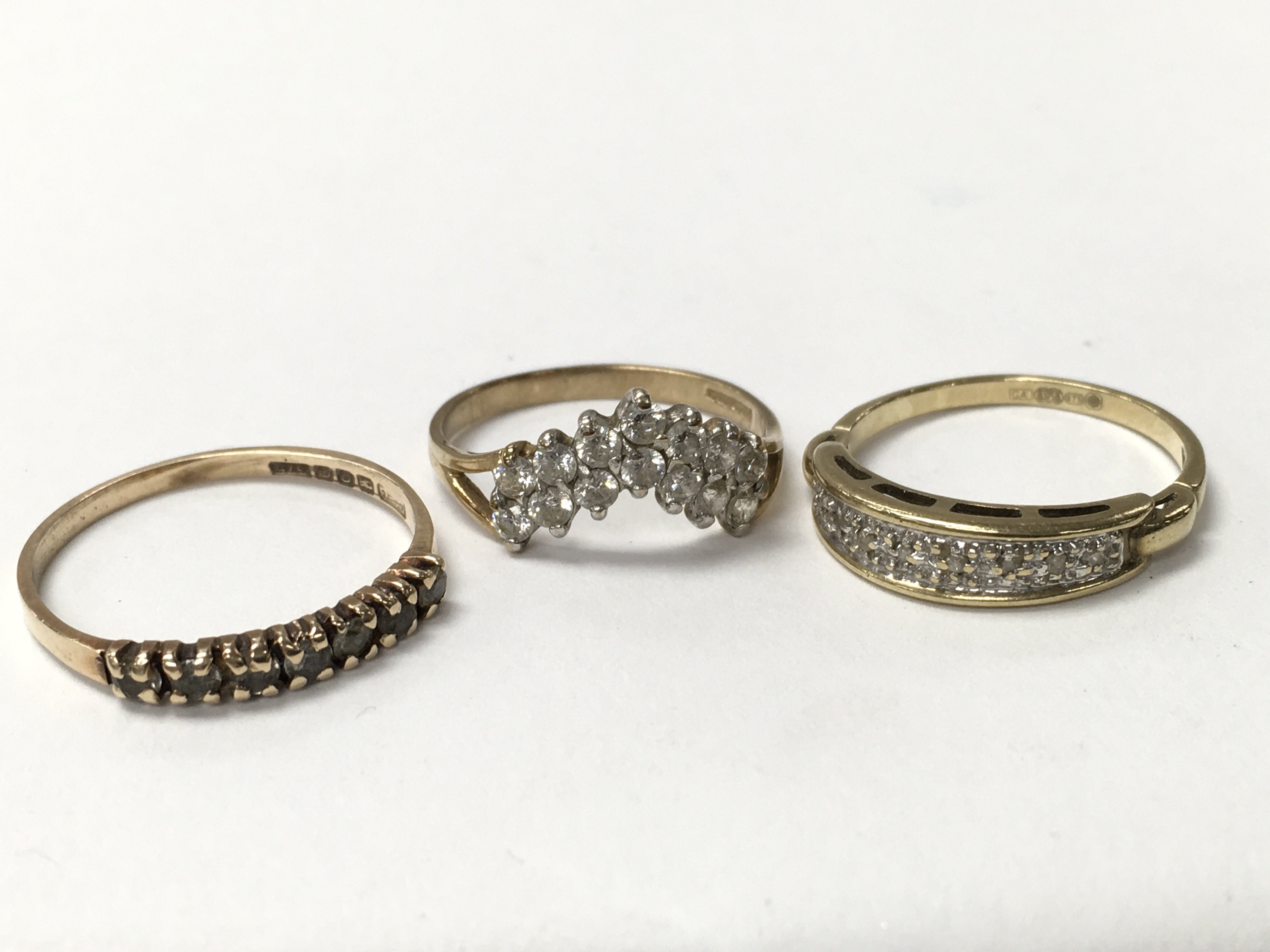 Three 9ct gold stone set rings.