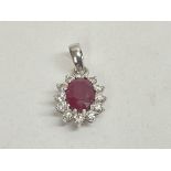 18ct white gold oval cut ruby and RBC diamond clus