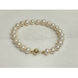 Pearl string bracelet with 9ct yellow gold ball cl