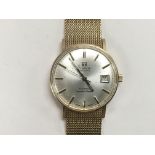 A 1960s 9ct gold Tissot Visodate Seastar Seven watch with baton numerals and date aperture, with app