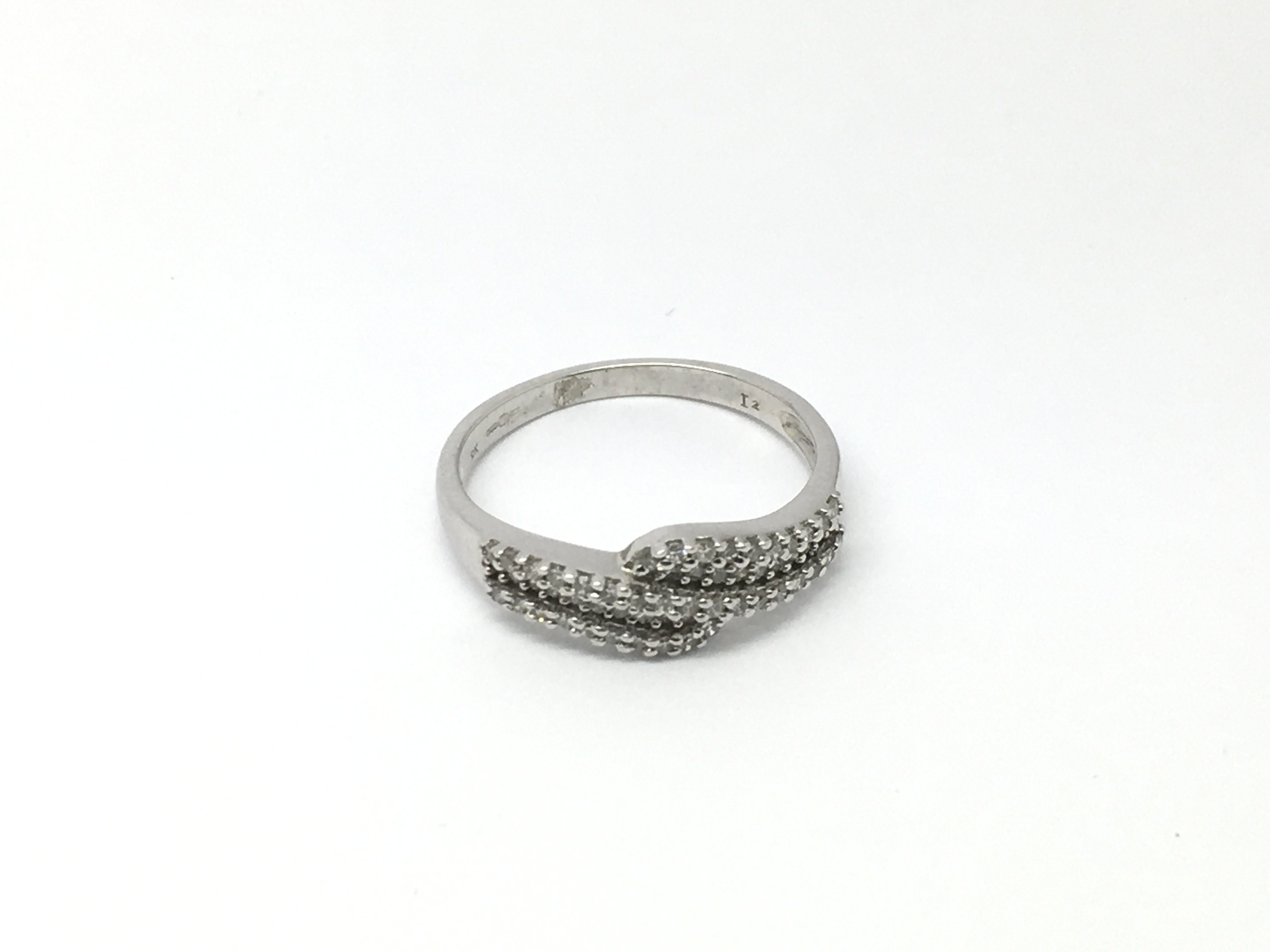 A 9ct white gold ring set with small diamonds, app