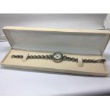 A silver and Marcasite ladies watch in a fitted bo
