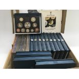 A collection of uncirculated coin sets.