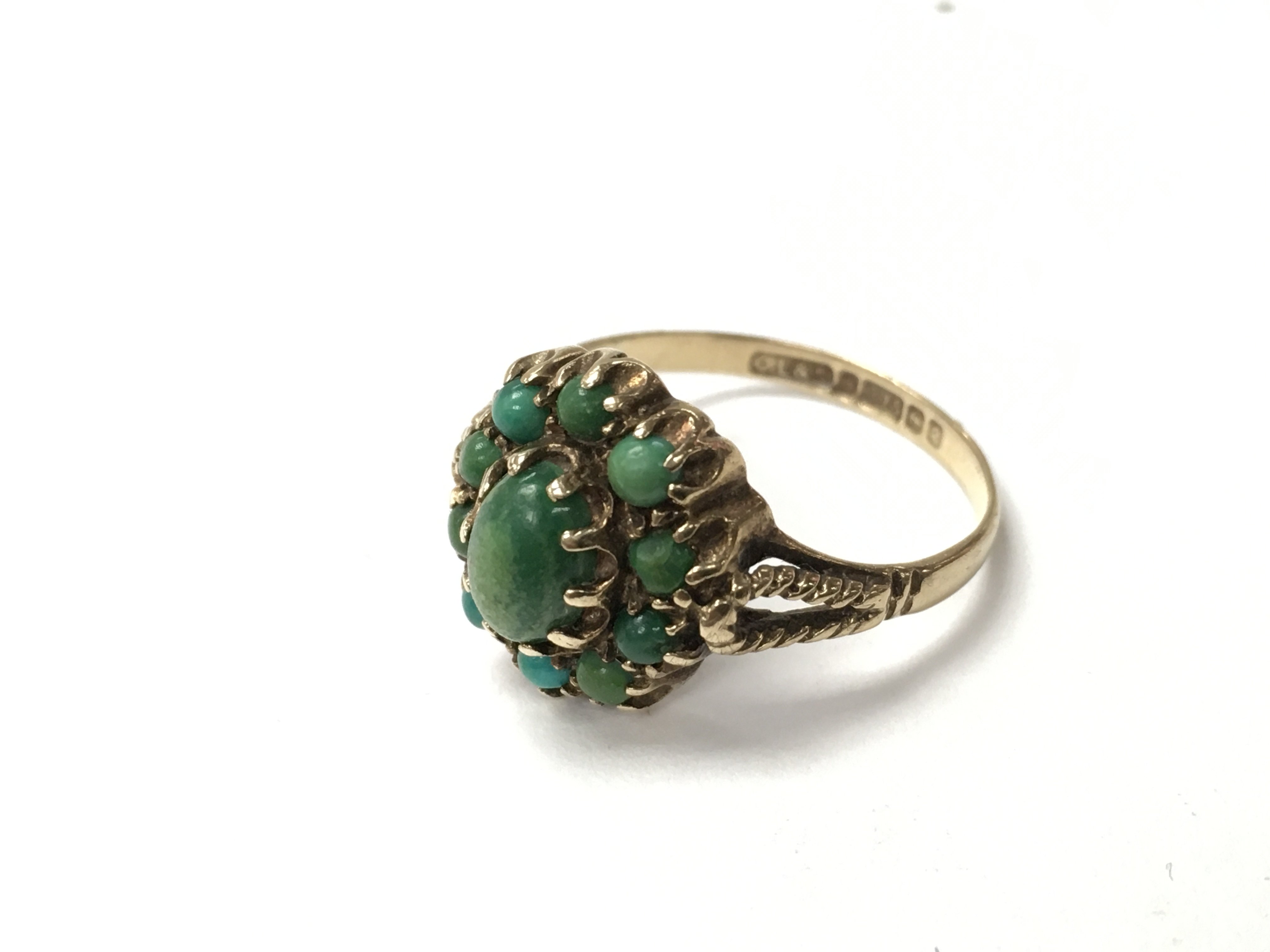 An Edwardian 9ct gold and turquoise set ring. The