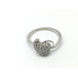 A 9ct white gold ring set with diamonds in a setti