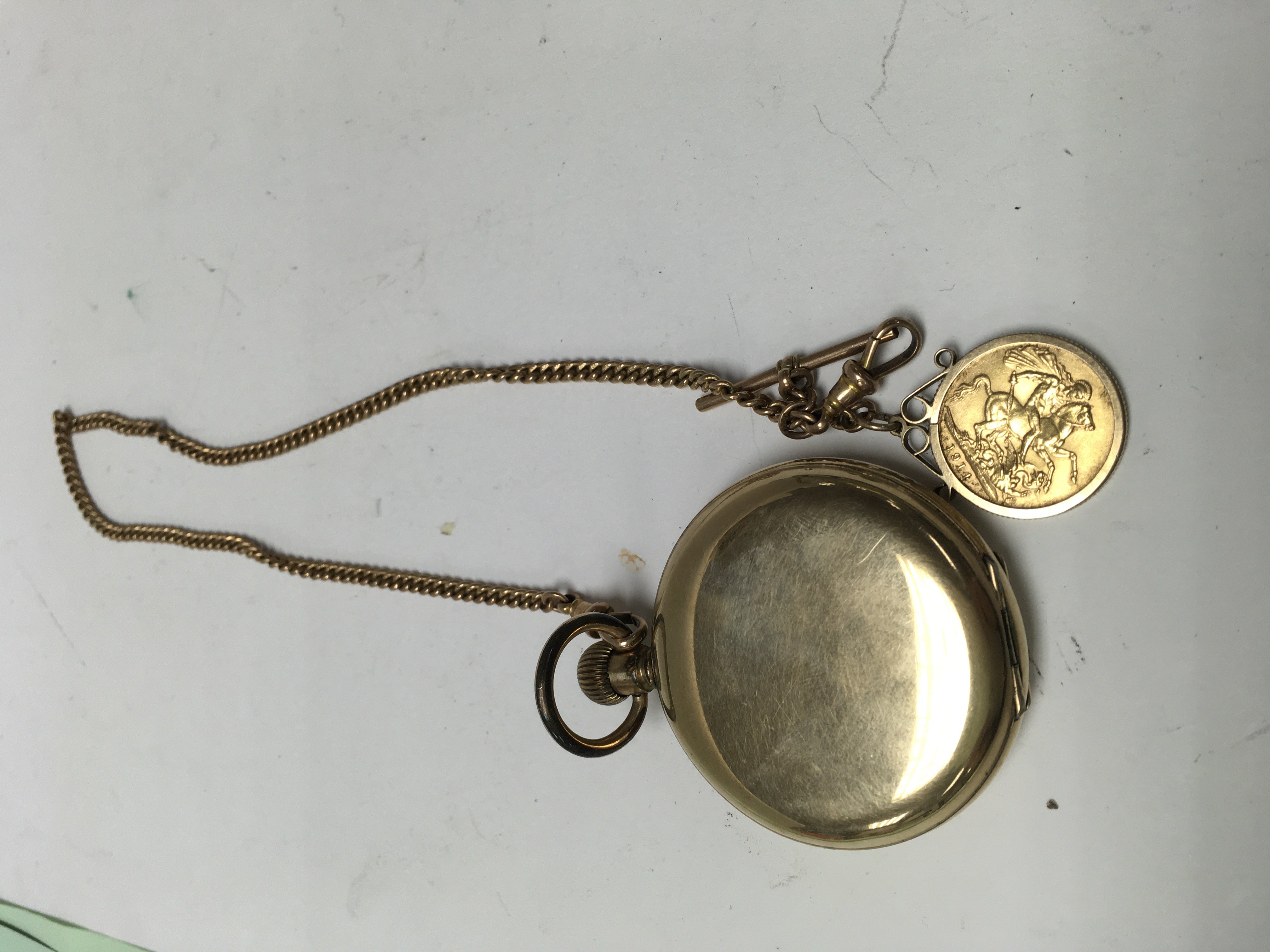 A gold plated pocket watch with attached 9 ct gold