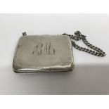 A silver case with attached chain total weigh 100