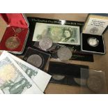 A collection of coins and bank notes including silver proof pound coin and a 1935 crown