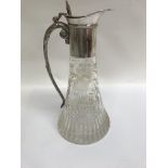 A Edwardian cut glass claret jug with floral desig