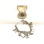 Silver charm bracelet and 1 individual charm.
