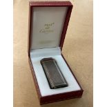 A boxed white metal Cartier cigarette lighter