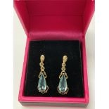 A pair of 9ct gold drop earrings set with blue top