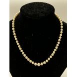 A graduated pearl necklace with a 14ct gold clasp.