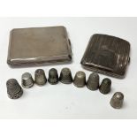 A collection of silver thimbles and two silver cig