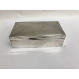 A silver cigarette box the hinged lid enclosing a