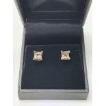 A pair of 9ct gold stud earrings set with smoky qu