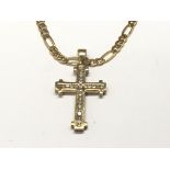 A 9ct gold stone set cross with attached 9ct gold