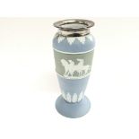 A light blue wedgewood vase with silver collar. Ap