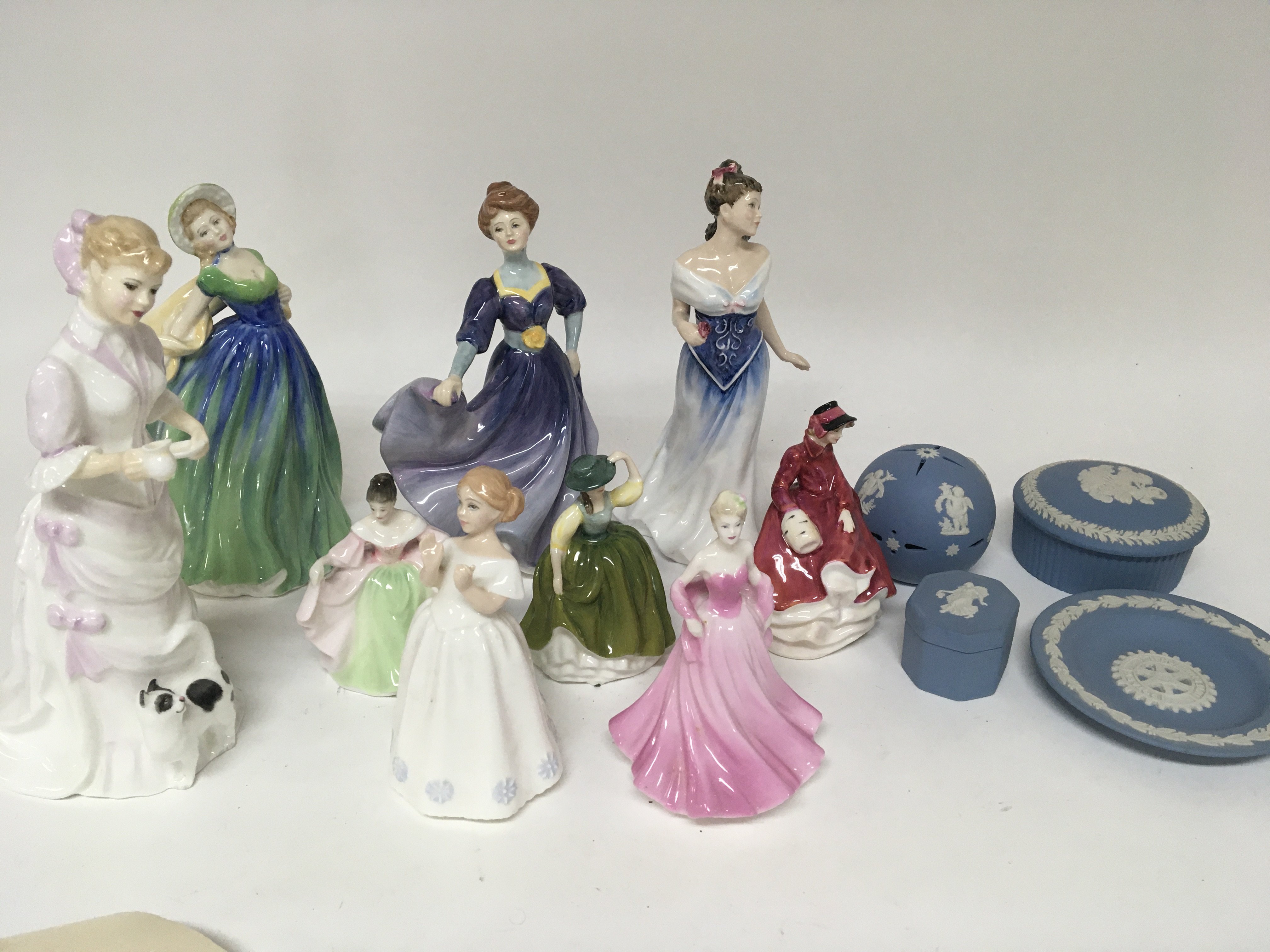 A collection of Royal Doulton and Coalport figures