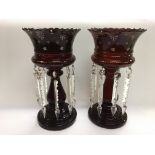 A pair of cranberry glass lustres with cut glass d
