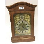 A walnut cased mantel clock with a brass dial silv