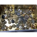 A large collection of replica military cap badges