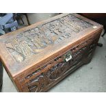 A carved Camphor wood chest the top carved with fi