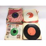 A tin of 7inch singles by various artists from the