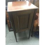 A mahogany pot cupboard with a single door on squa