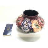 A pansy Moorcroft vase.