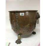 A 19th century copper and brass log bin with lion