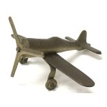 A small brass model aeroplane.