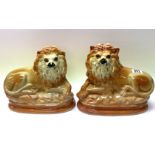 A pair of Staffordshire pottery lion figures with