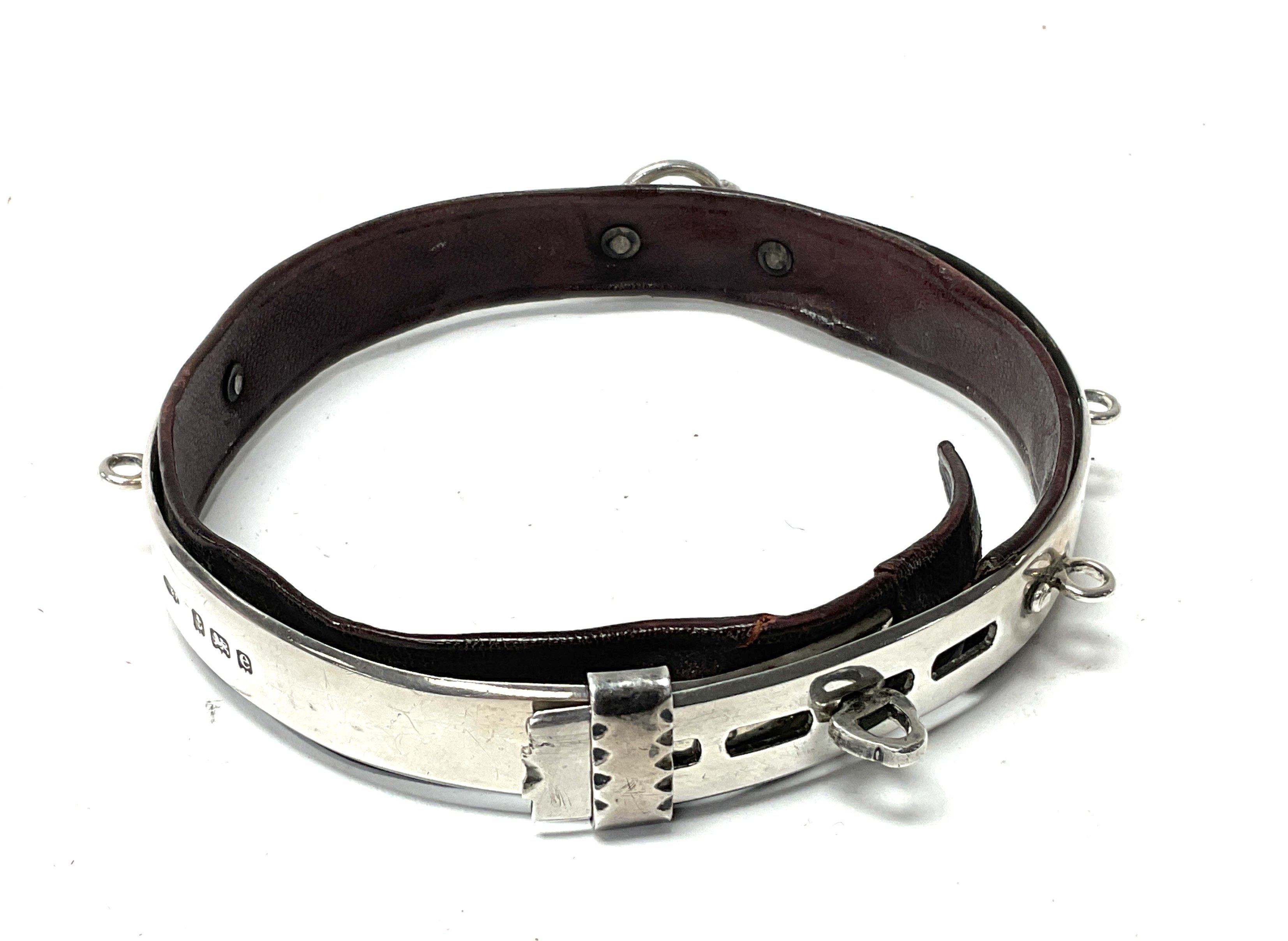 A hallmarked silver and leather mounted dog collar