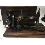 A Vintage early model Singer sewing machine in a f