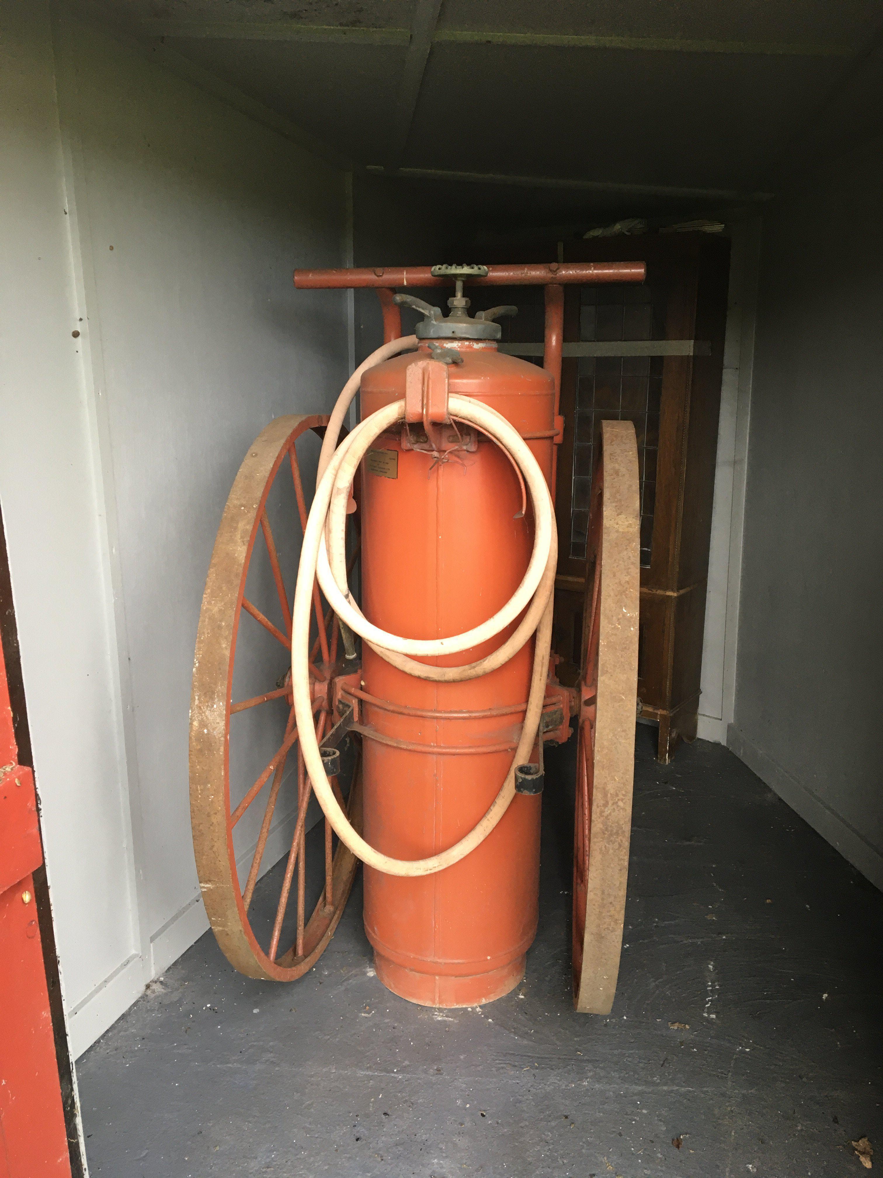 A Rare large Air Minister Aircraft runway fire extinguisher on large cast wheels. 162cm high.