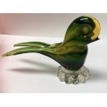 A murano glass paperweight in the form of a bird.